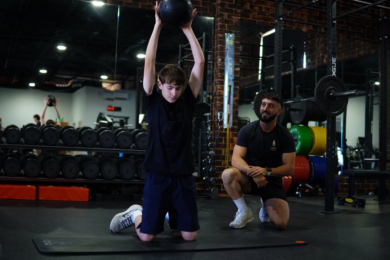 Coached medicine ball session on the gym floor