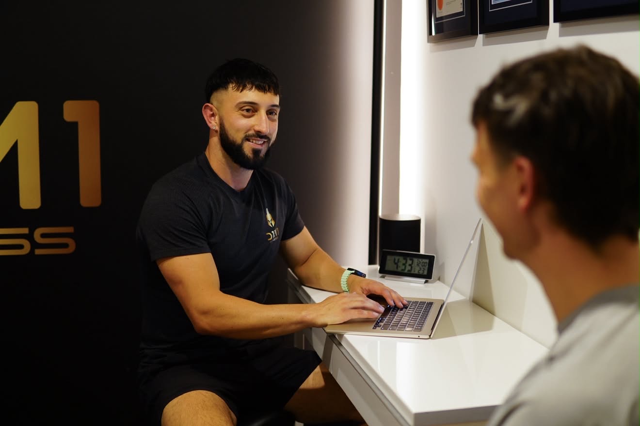 Coaching consult at the desk inside D1M1 Fitness
