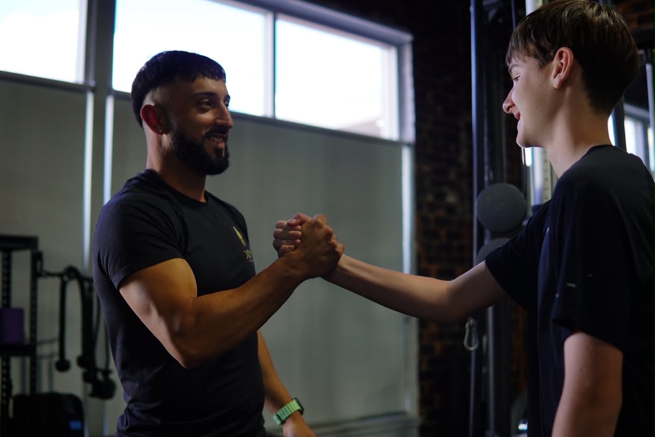 Coach and client shaking hands after a session