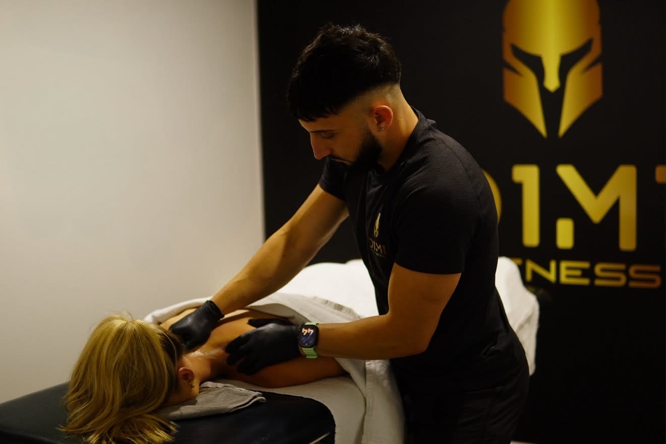 Remedial massage treatment at D1M1 Fitness Fyshwick, gold logo wall behind