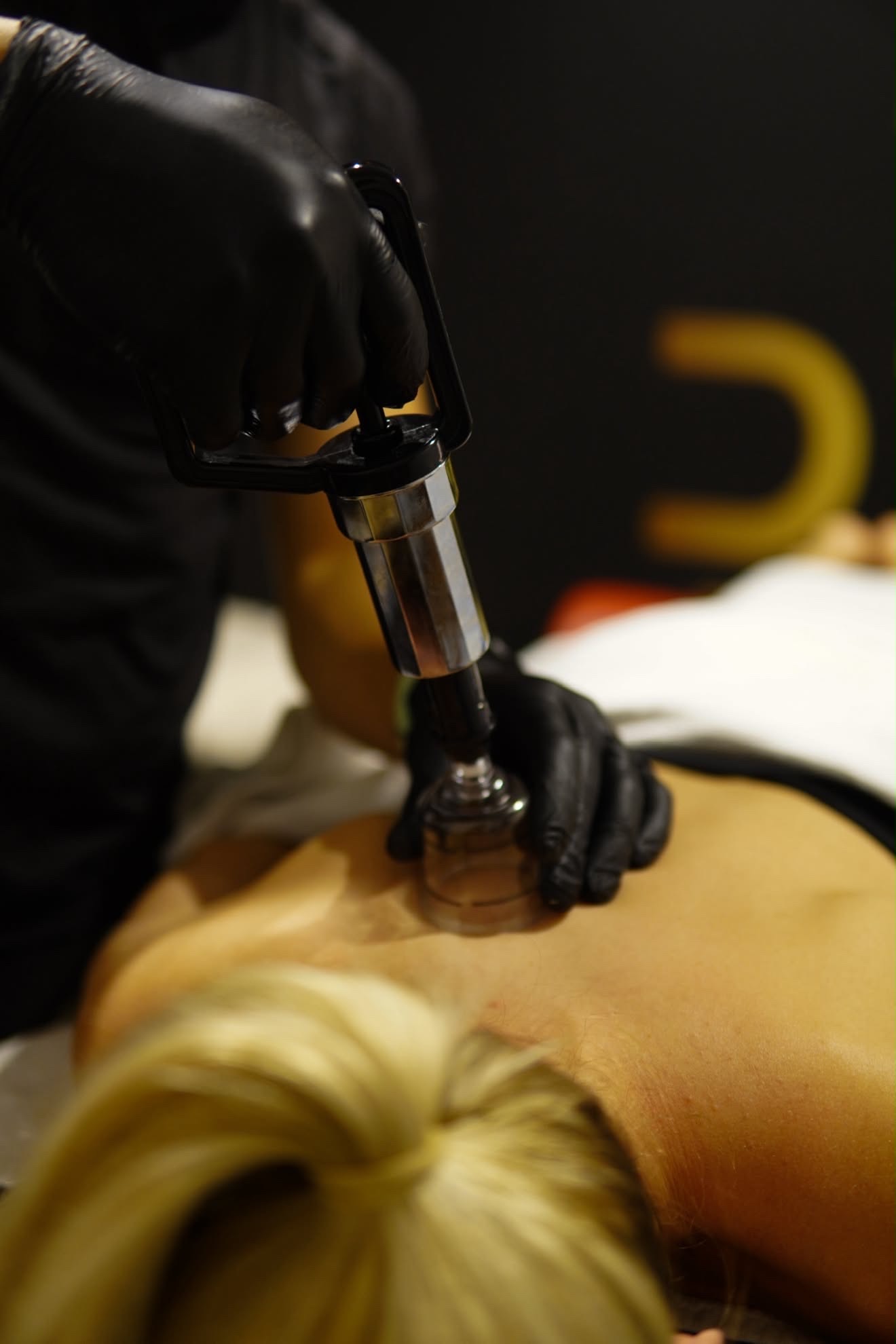 Percussion therapy during a remedial massage treatment at D1M1 Fitness