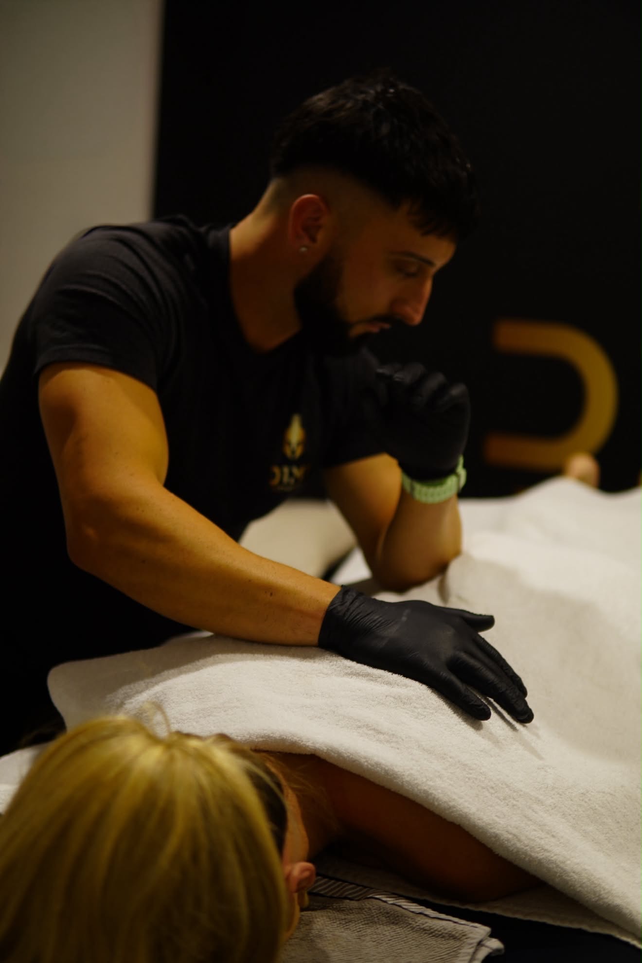 Hands-on remedial massage treatment over towel